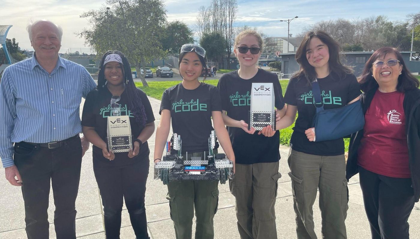 All-girls VEX robotics team with trophies